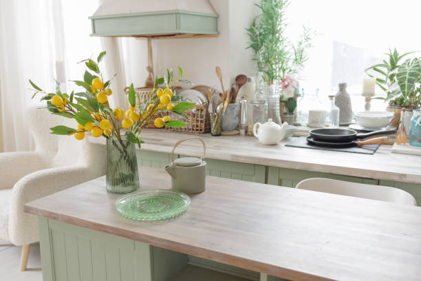 istock Cozy Kitchen with Green Cabinets and Yellow Flowers 2197973542
