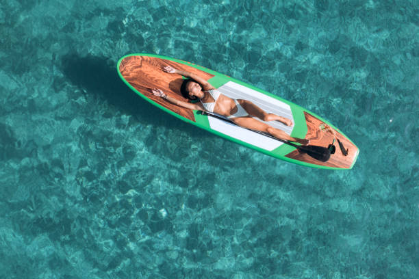 istock Girl on stand up paddle board driving 2197974345
