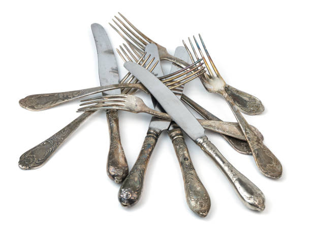 istock Various antique silver forks and knives piled together 2197975429