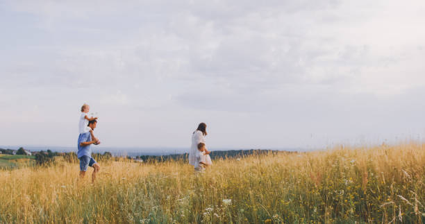 istock Joyful Caucasian Family Strolls Through Wheat Field 2197976586
