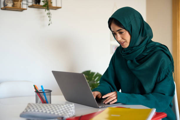 istock Young professional woman working on laptop 2197977480
