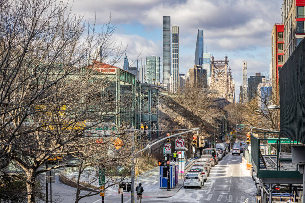 Queensboro Plaza Station, Queens, New York, United States - January 15th 2025:  Viewto the elevated station towards Mid Manhattan skyline on a clear and cold winter day