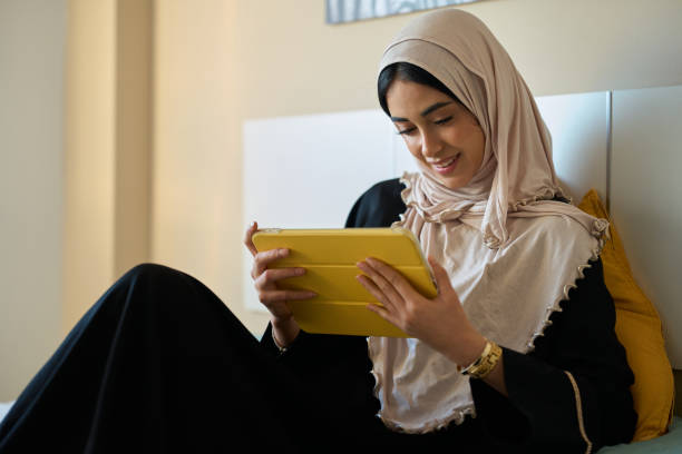 istock Young adult woman using tablet at home 2197977665