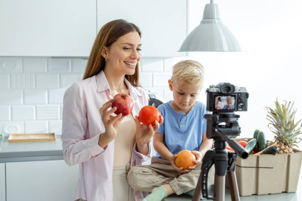 istock Mother and son recording a healthy food tutorial in a modern kitchen 2197981099