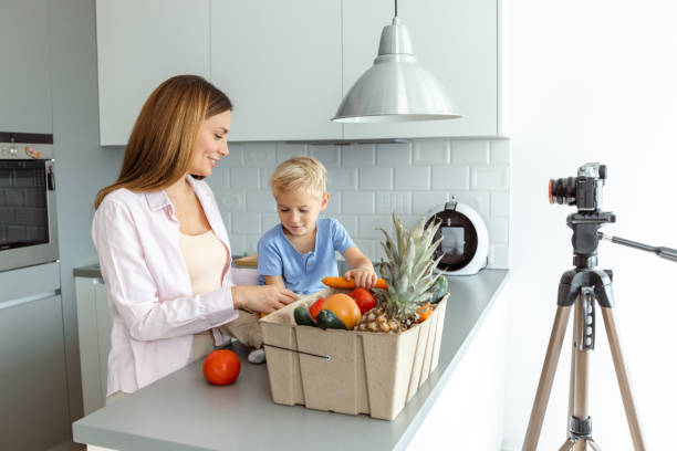 istock Mother and son recording a healthy food tutorial in a modern kitchen 2197982074