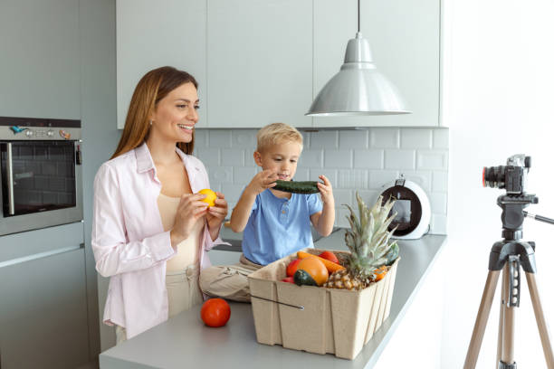 istock Mother and son recording a healthy food tutorial in a modern kitchen 2197982121