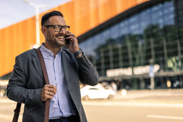 istock Businessman walking in the city, using phone 2197983008