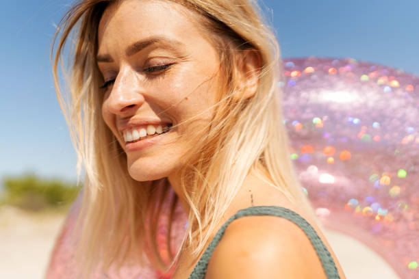 Photo of a woman who enjoing with inflatable swim ring at the beach