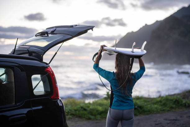 istock Surfer Girl Next to Car With Surfboard. One Wave Before Work 2197983973