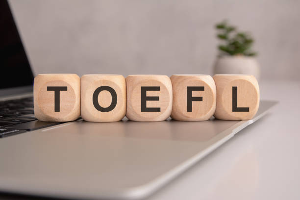 istock wooden cubes spelling 'TOEFL' placed on a laptop, symbolizing English proficiency testing and academic readiness 2197985458