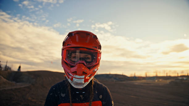 istock Confident Female Motocross Rider Against Sunset Backdrop 2197986282