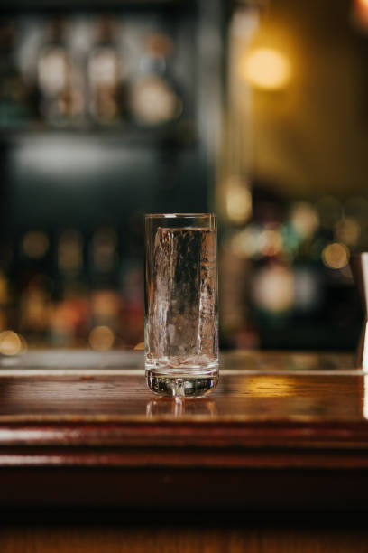 istock Crystal clear ice cube in a glass on a bar 2197987658