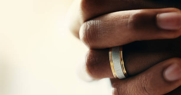 istock Hands, closeup and ring on finger for marriage, love and romantic commitment with mockup space. Person, wedding band and jewelry accessory with shine of valuable or precious metal symbol for loyalty 2197989301