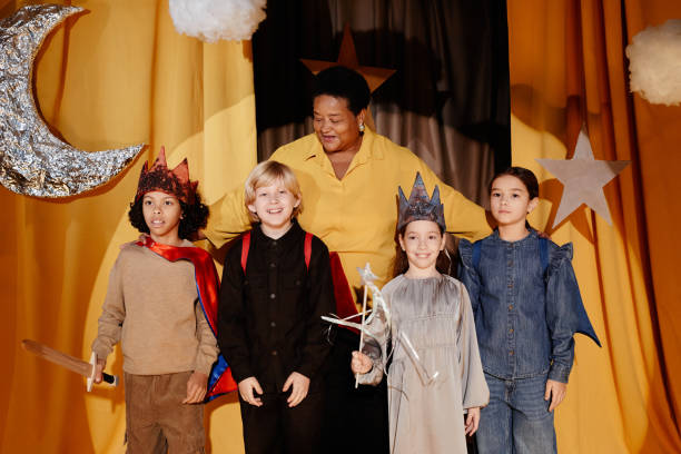 istock Children Wearing Costumes Standing on Stage Performing 2197989719