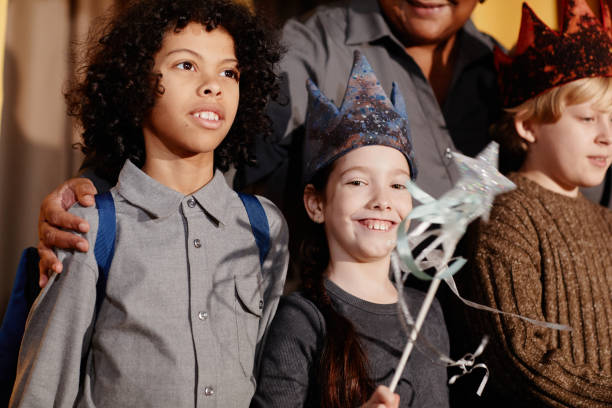 Group of diverse children at a celebration party, smiling and having fun, wearing costumes and holding props. Showing joy and friendship