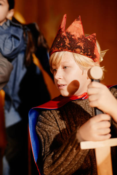 istock Playing Knight Holding Wooden Sword and Wearing Crown 2197989754