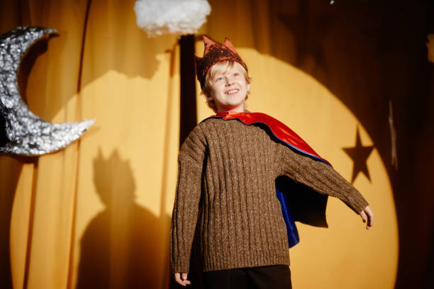 istock Smiling Child Performing in Costume under Stage Lights 2197989769