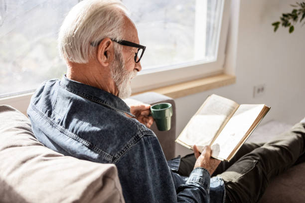 istock Senior Man Enjoying a Book and Coffee 2197990350