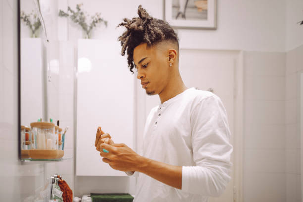 istock At home - young man brushing his teeth 2197990387