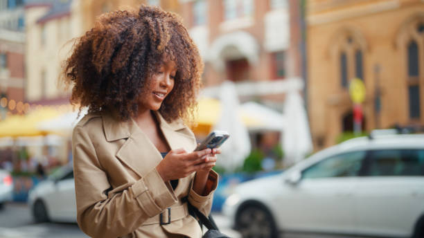 istock Fashionable Young Businesswoman Smiling While Using Her Smartphone 2197992555