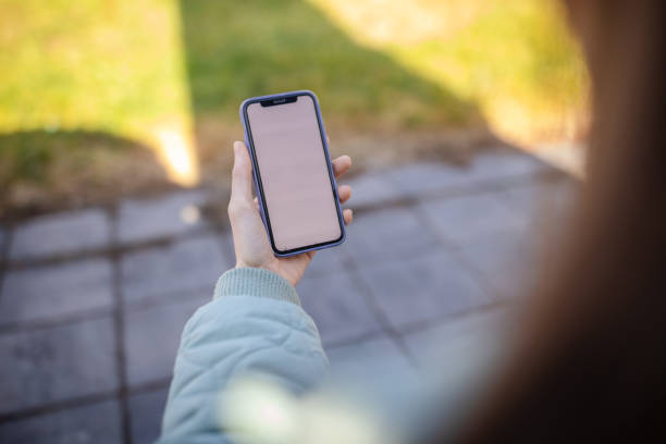 istock Patient enjoys outdoor time while using her phone for healthcare and wellness apps during a sunny day 2197993847