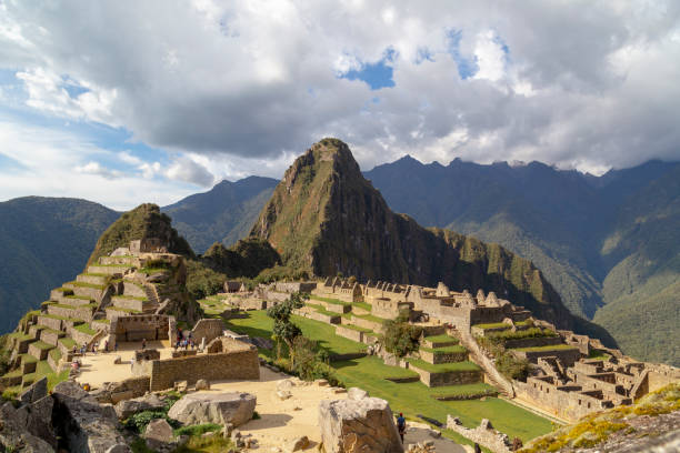 istock Machu picchu ruins shining under cloudy sky in peruvian andes mountains 2197995107