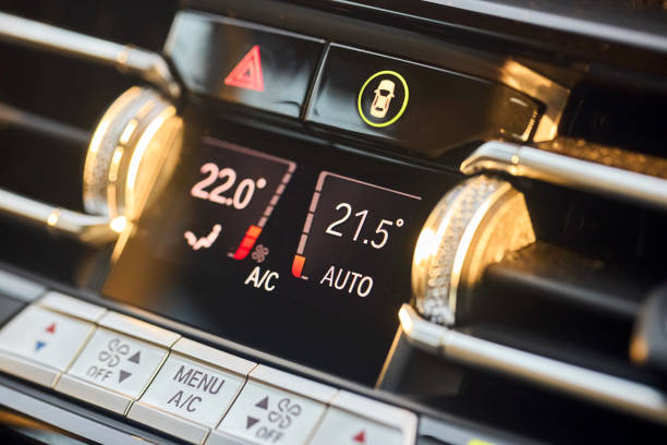 istock Automotive detailing climate control display dashboard with mode buttons close up. Luxury contemporary car interior detail selective focus shot. 2197995743