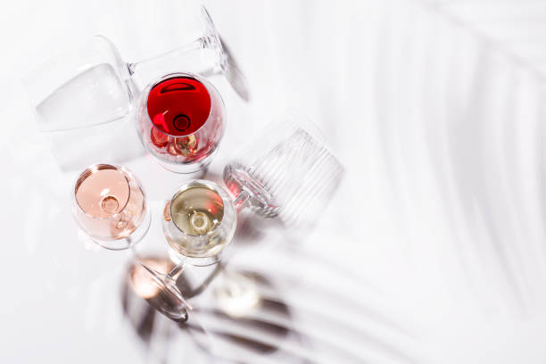 istock Three wine glasses filled with red, white, and rose wine 2197995892