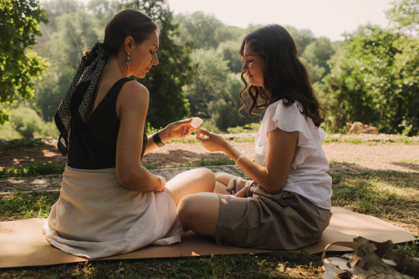 istock Mentor and student before Mindful meditation and yoga in an open area. Deep relaxation and inner contemplation of people. Facilitating meditative experience. Part of the series. 2197996425