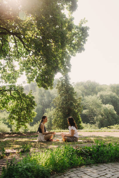 istock Mentor and student before Mindful meditation and yoga in an open area. Deep relaxation and inner contemplation of people. Facilitating meditative experience. Part of the series. 2197996460