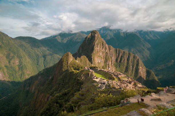istock Machu picchu ruins shining under cloudy sky in peru 2197996515