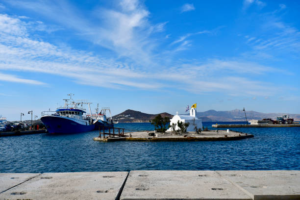 Naxos, Greece - September 20, 2024: a small island in the harbor of Naxos with a chapel on it