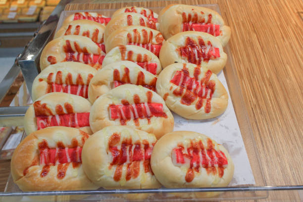 Delicious Freshly Baked Buns with Toppings on Wooden Surface