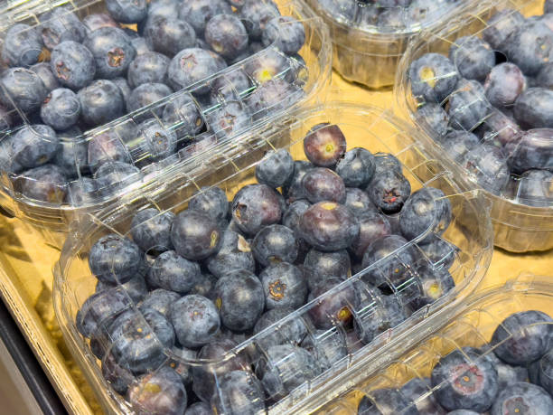 istock Fresh organic blueberries in plastic containers at market display 2197998956