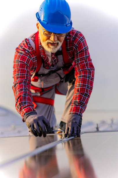 istock Technician checking solar power plant installed on building roof stock photo 2197999628