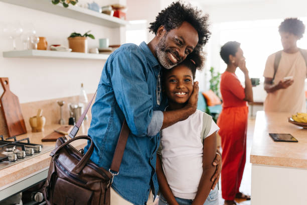 istock Mature dad embraces his young daughter before leaving for work in the morning 2198000188