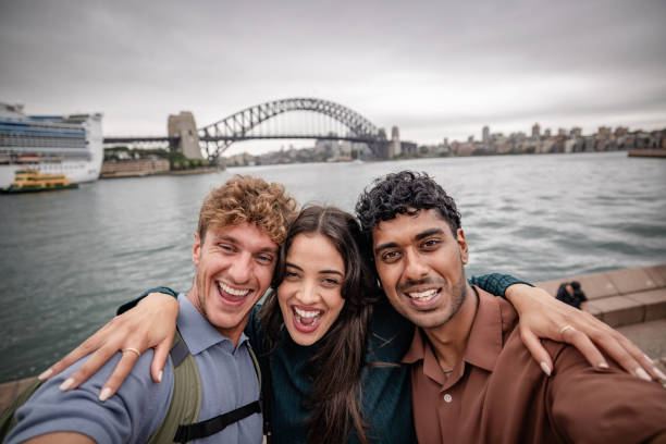 istock Smiling friends embrace joy at Sydney Harbour with iconic bridge backdrop on a weekend adventure 2198002279