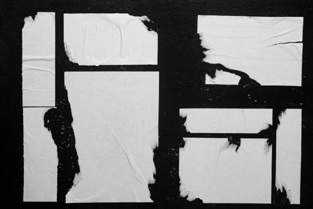 istock Close-up of posters glued to a black wall. 2198002507