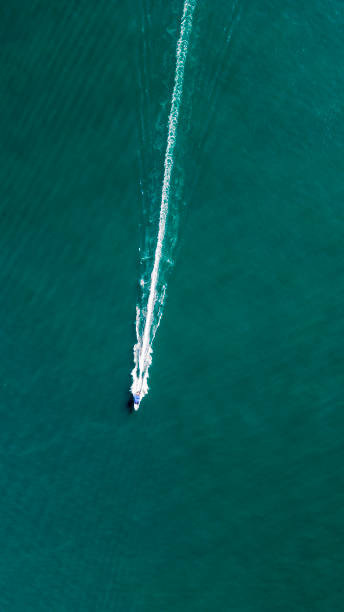 istock Speedboat sails across calm sea 2198002815