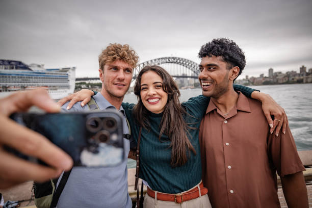 istock Young adults enjoy a fun day by the harbor in Sydney, Australia while capturing memories together 2198002910