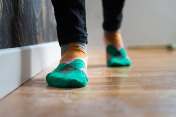 Walking on wooden floor with colorful socks