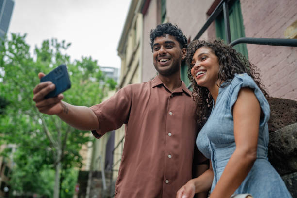 istock Young adults enjoy a sunny weekend taking selfies together in Sydney, Australia 2198004067