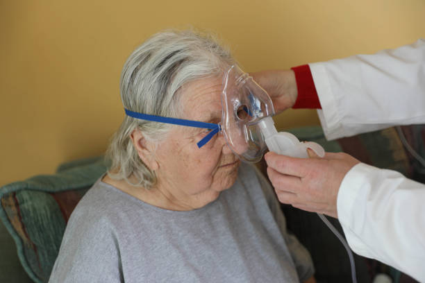 istock A grandmother with an oxygen mask resting in her bed. 2198006204