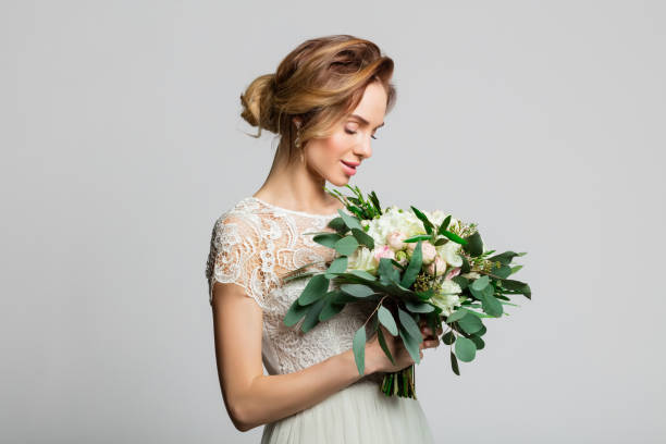istock Portrait of beautiful bride holding flowers 2198006435