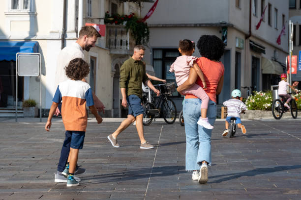 istock Multiracial Family Walking Joyfully in City Square 2198008417