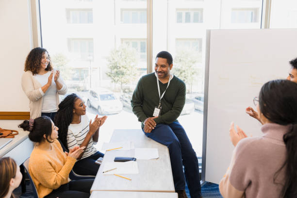istock Diverse Group of Students Applauding Professor in Classroom 2198009028