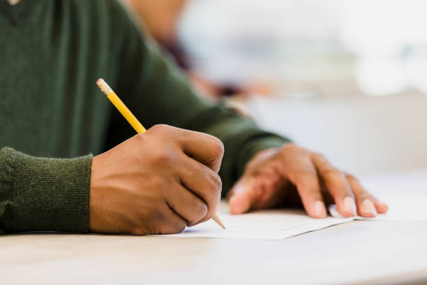 istock Person Writing with Pencil on Paper, Close-up 2198009056