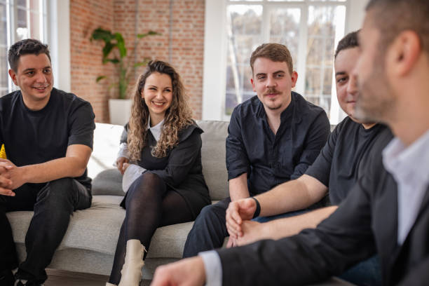 istock Group of adults enjoying a friendly conversation in a cheerful indoor setting during a sunny afternoon 2198010103