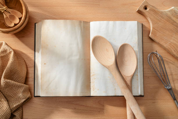 istock Open cookbook with blank pagesshot from above on wooden table. Copy space on book 2198011806