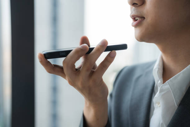 Confident business woman speaking on her smartphone in speaker mode